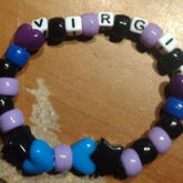 a purple blue and black bracelet with the 
    name virgil on it
